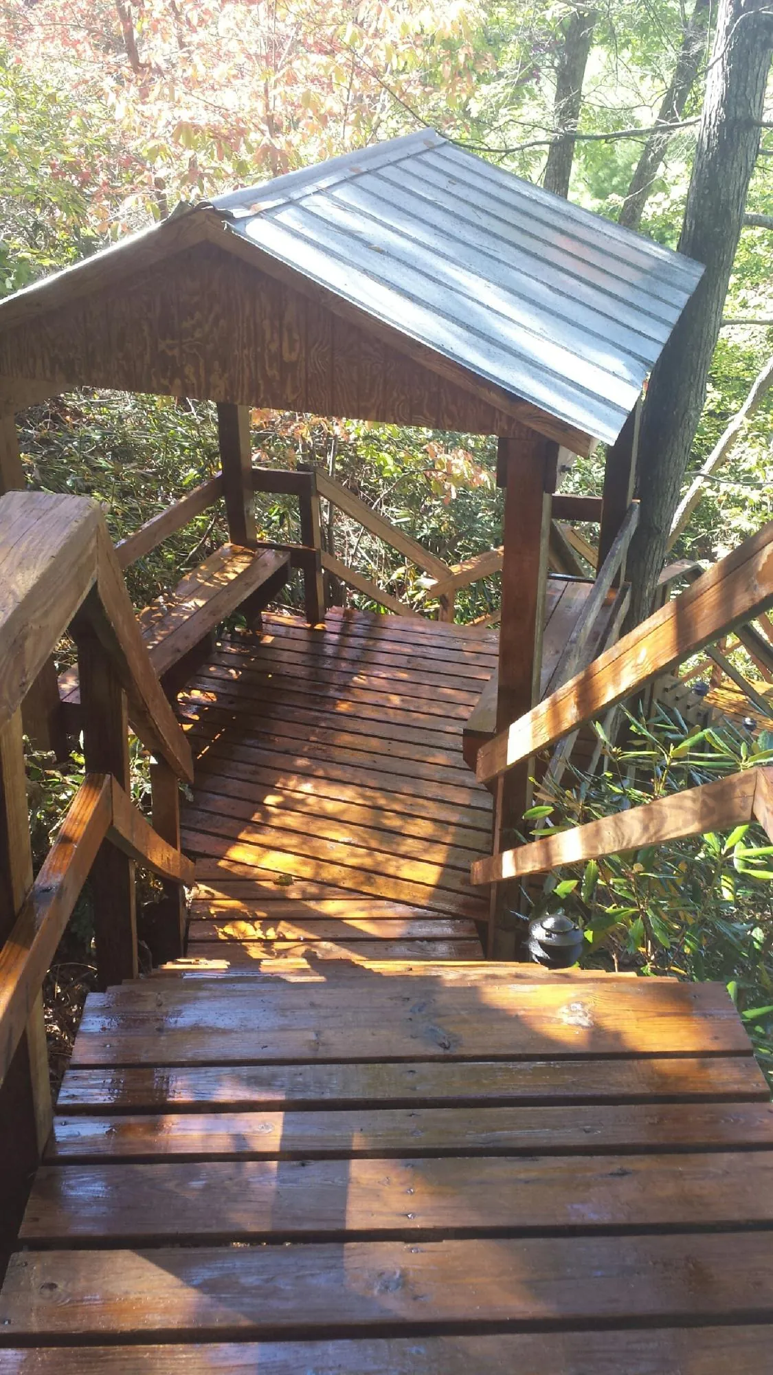 Freshly stained wood walkway and covered shelter with a metal roof in Greenwich