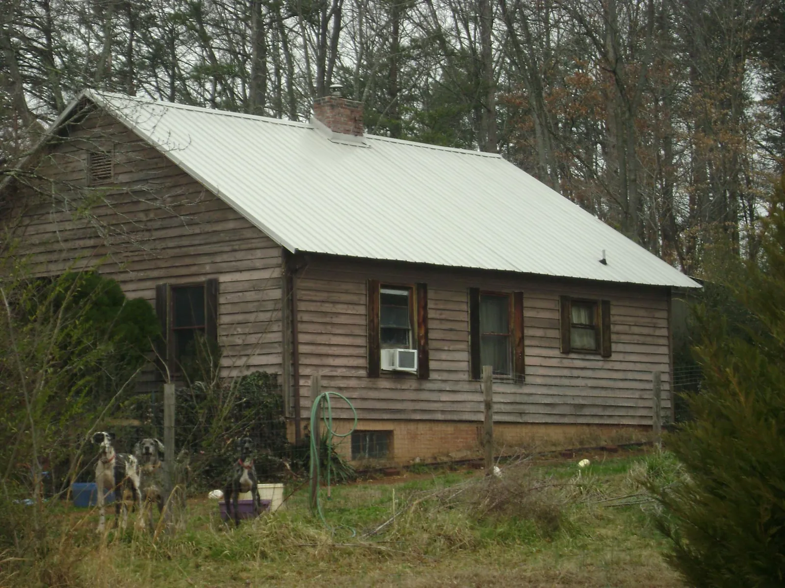 White metal roof on an old wood sided farmhouse, from a Metal Roof Installation job in Greenwich